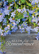 Floral design with 'Seeds of Remembrance' text on a wooden background