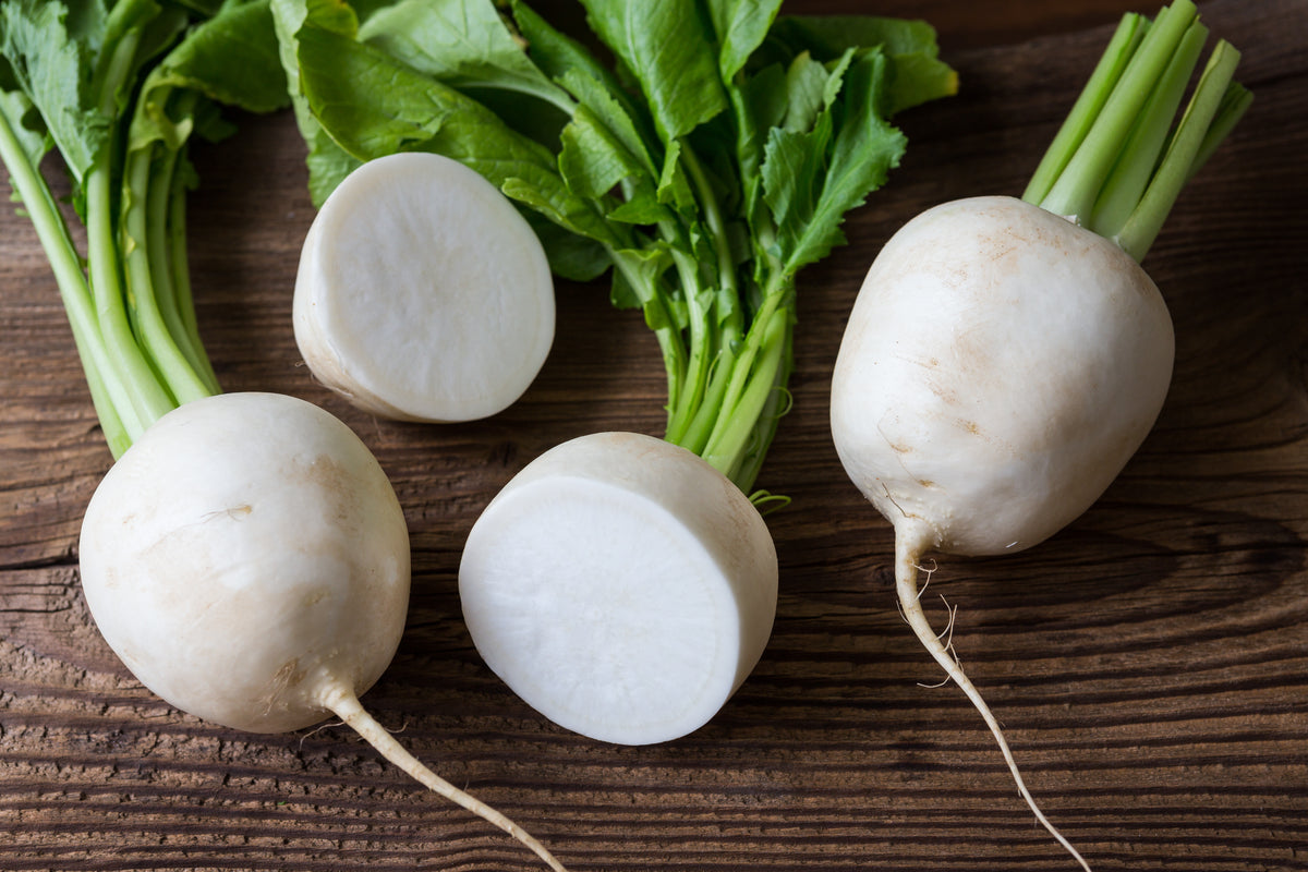 Fresh turnips on a rustic wooden table.