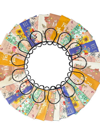 Circular arrangement of colorful seed packet cards with floral designs and text on a white background