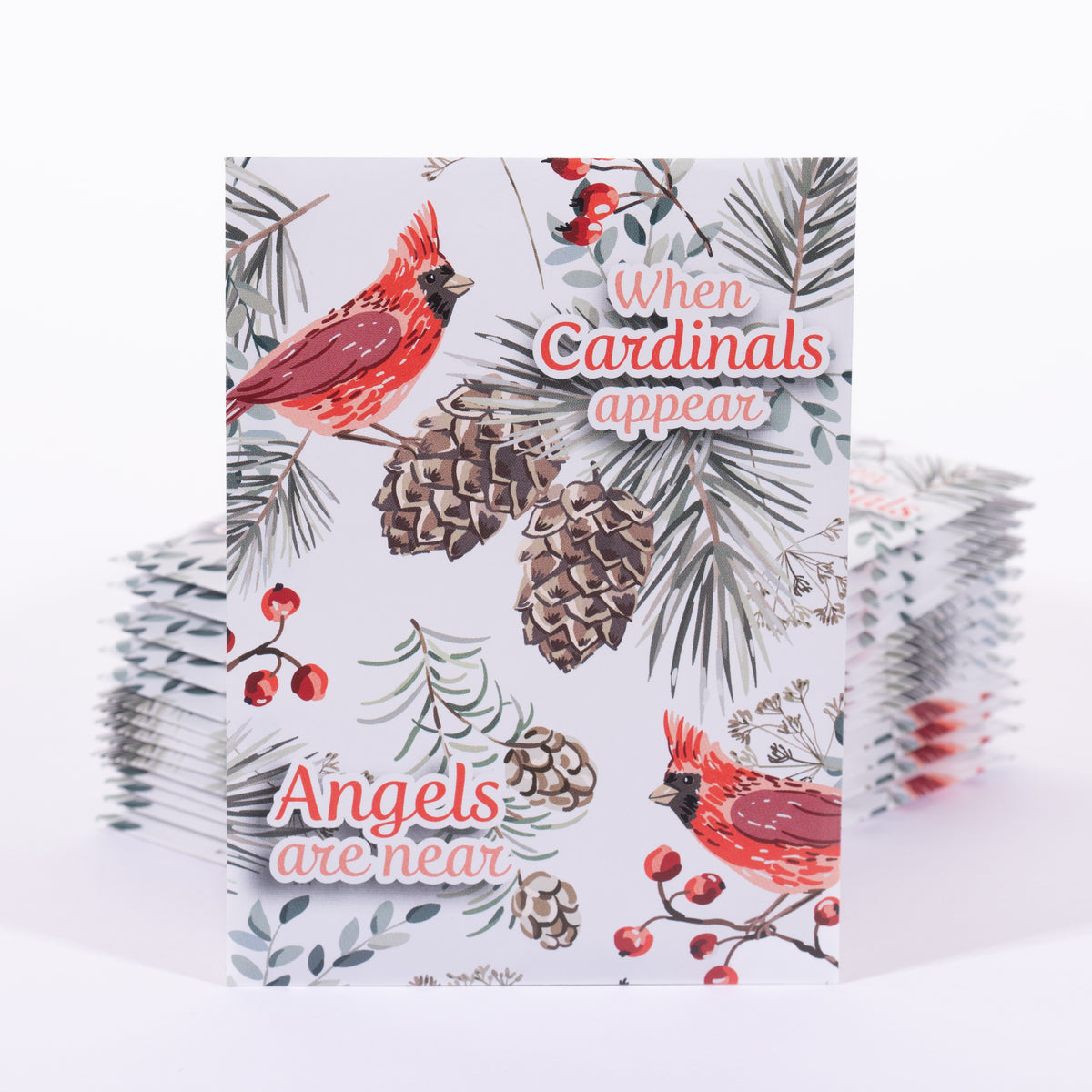 Stack of greeting card seed packets with cardinal design and text reading "When Cardinals appear Angels are near" on a white background