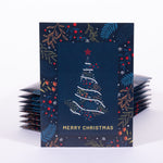 Stack of Christmas card seed packets with a decorative tree design on a dark blue background