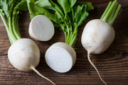 Fresh turnips on a rustic wooden table.