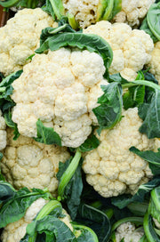 Heads of cauliflower piled together.